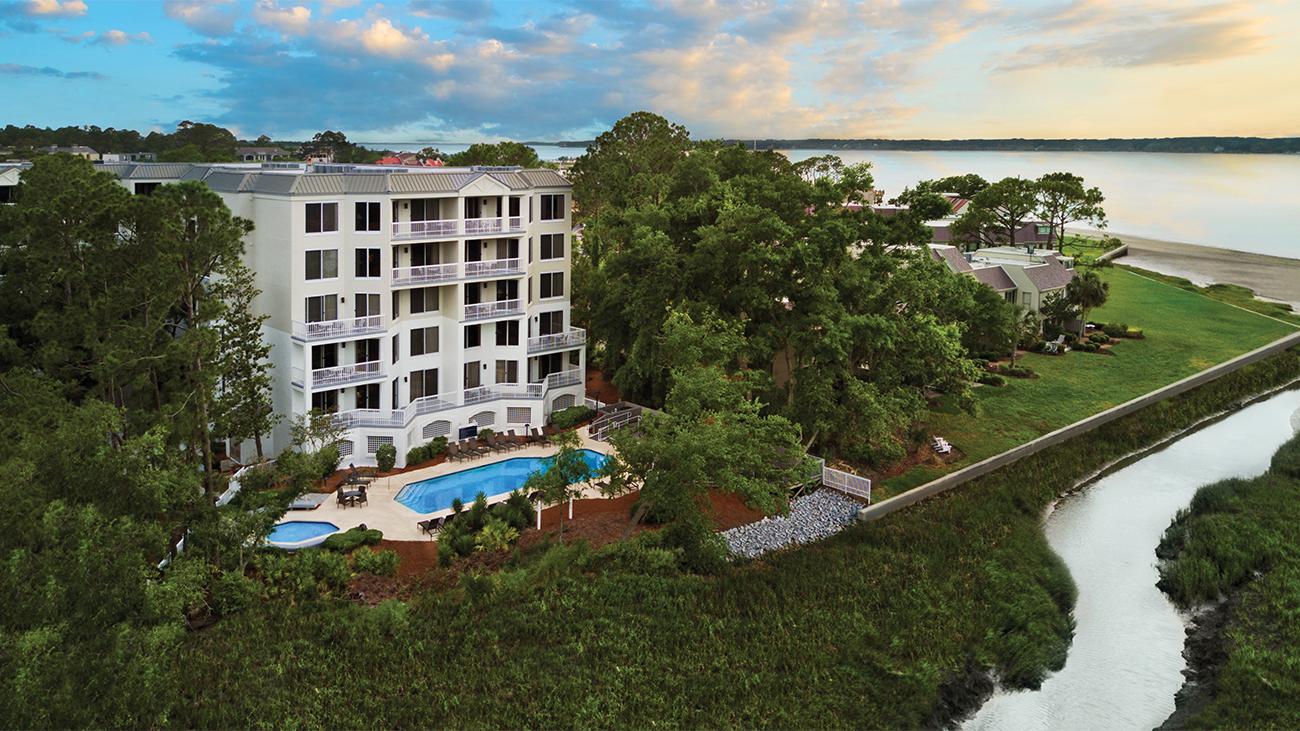 Exterior of Marriott's Harbour Club timeshare resort showing pool, grounds and nearby beach